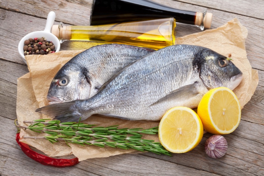 photodune-8853212-fresh-dorado-fish-cooking-with-spices-and-condiments-l.jpg